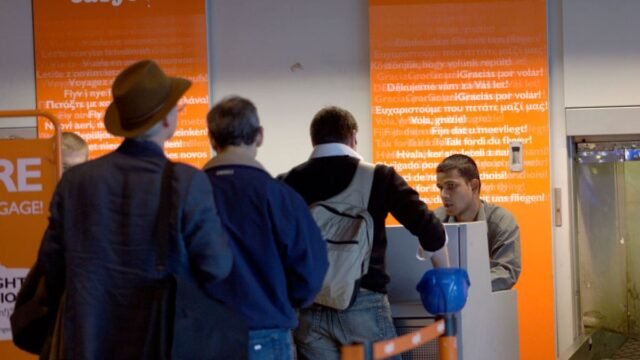 1779956877_1_easyJet-check-in-queue-with-businessmen-in-suits-with-carry-on-baggage.jpg