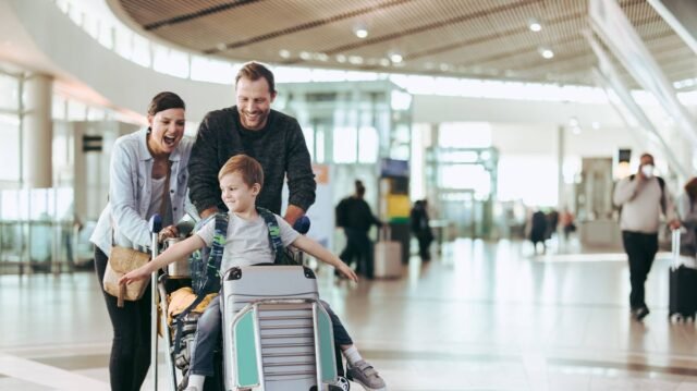 1780825682_0_Couple-pushing-trolley-with-their-child-at-airport.jpg