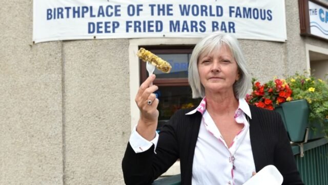 1781446675_0_owner-Lorraine-Watson-outside-of-The-Carron-Fish-Bar-with-a-battered-mars-bar.jpg