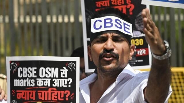 A-person-protests-in-New-Delhi-against-the-CBSE-ov_1781152996355_1781153011449_93a0bc2c-2d84-4d8e-ab.jpeg