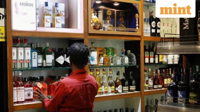 A-salesman-arranges-liquor-bottles-inside-a-liquor_1780827819975_1780827830696_c54557fb-3a37-4700-85.jpeg