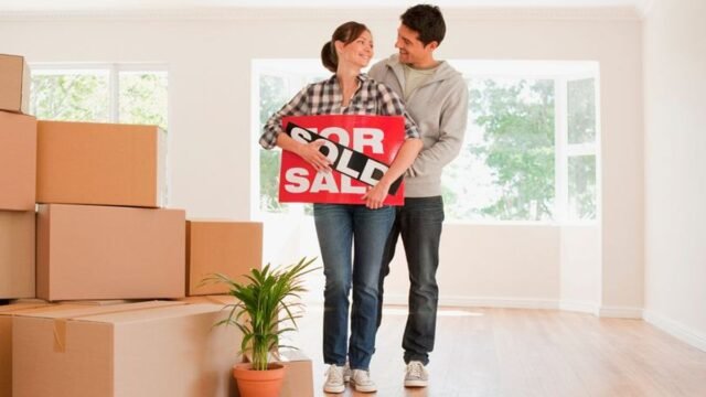 1784723585_4_Couple-holding-sold-sign-for-their-new-house.jpg