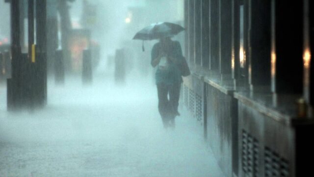 1784790056_0_Person-under-umbrella-in-hammering-rain.jpg